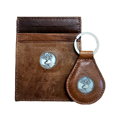 The perfect gift, the Dynasty Bifold Buck Wallet & Keyring is constructed from premier full grain leather and has a hand-oiled stylish finish. Beautiful pieces for your collection. 6 Card Slots 2 Storage Pockets 1 ID Window Exterior Easy Access Pocket Strong Exterior Money Clip Slim Minimalist Design Weber's Signature Buck Concho Money Clip Holds: 10+ Bills Dimensions: 4.2"L x 3"H RFID Protection Color: Brown