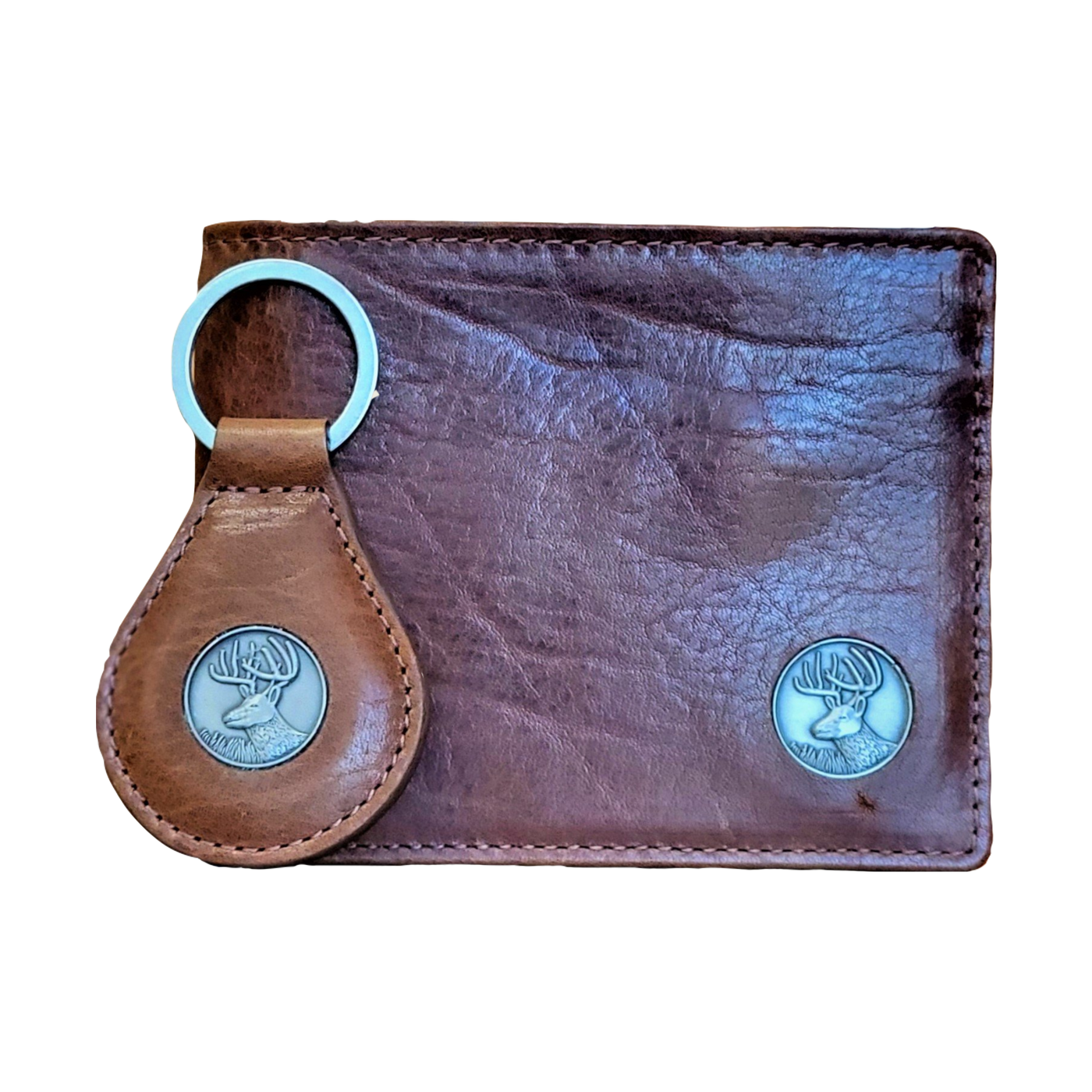 The Dynasty Bifold Buck Wallet & Keyring, harnesses the hunt for any avid outdoorsman. The premier full grain leather and hand-oiled stylish finish set this among the top for stocking stuffers. Don't miss out! 8 Card Slots 2 Storage Pockets Leather Tipped Bill Divider Signature Buck Concho Dimensions: 4.5"L x 3.5"H RFID Protection Color: Brown