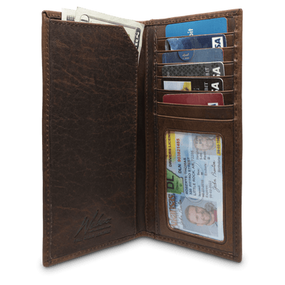 The Dynasty Rodeo Elk Wallet comes in premier full grain leather and a beautiful hand-oiled stylish finish, topped with a signature elk concho. A classic piece to have in your collection! 7 Card Slots ID Window 3 Bill/Receipt Pockets Exterior Easy Access Pocket Weber's Signature Elk Concho Dimensions: 3.67"L x 7.25"H RFID Protection Color: Brown