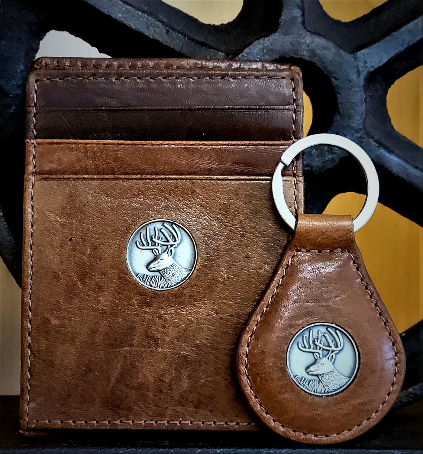 The perfect gift, the Dynasty Bifold Buck Wallet & Keyring is constructed from premier full grain leather and has a hand-oiled stylish finish. Beautiful pieces for your collection. 6 Card Slots 2 Storage Pockets 1 ID Window Exterior Easy Access Pocket Strong Exterior Money Clip Slim Minimalist Design Weber's Signature Buck Concho Money Clip Holds: 10+ Bills Dimensions: 4.2"L x 3"H RFID Protection Color: Brown